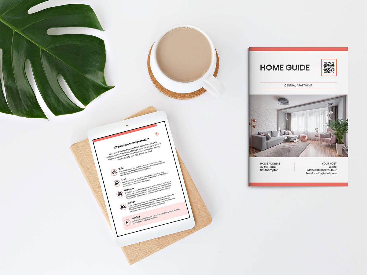 House manual booklet and tablet showing the digital house manual laid on a table with a cup of coffee and a large green leaf as decoration.